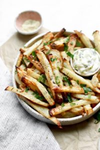 Delicious homemade French fries with fresh herbs and garlic
