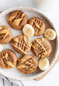 Healthy Peanut Butter Banana Cookies with a drizzle of peanut butter