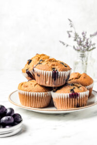 Fluffy Almond Flour Blueberry Muffins stacked on a plate